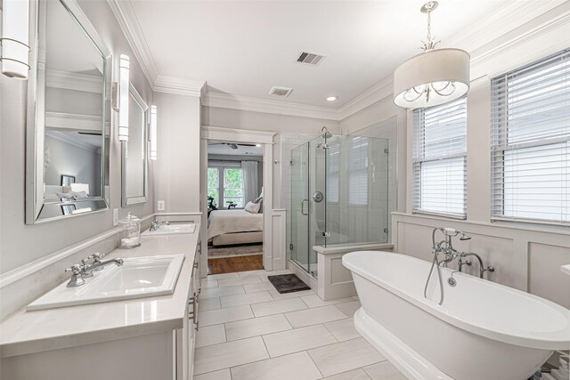 bathroom featuring independent shower and bath, crown molding, vanity, and tile patterned floors