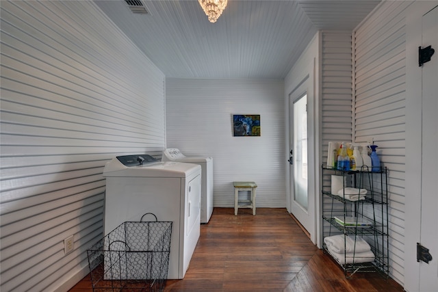 clothes washing area featuring dark wood-type flooring and washer and dryer