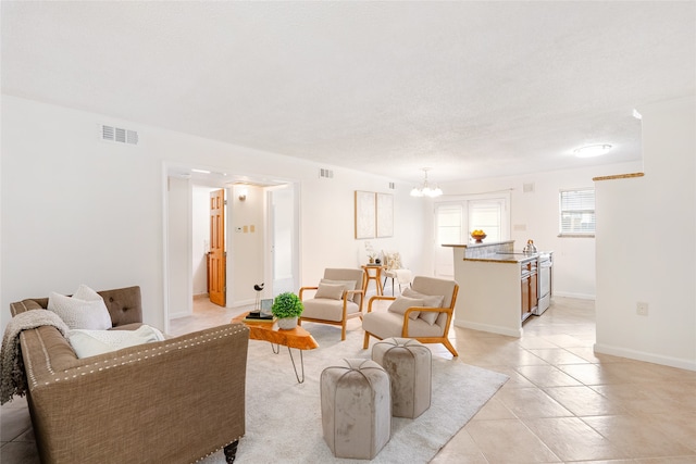 living room featuring a chandelier and light tile patterned floors