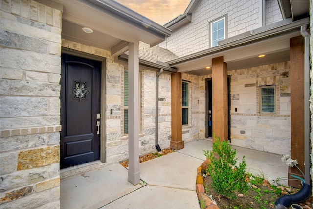 exterior entry at dusk with covered porch