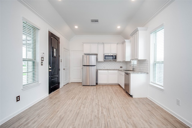 kitchen with white cabinetry, appliances with stainless steel finishes, and plenty of natural light