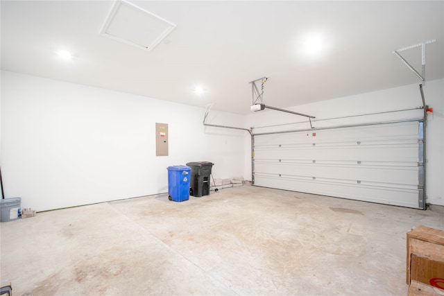 garage with a garage door opener and electric panel