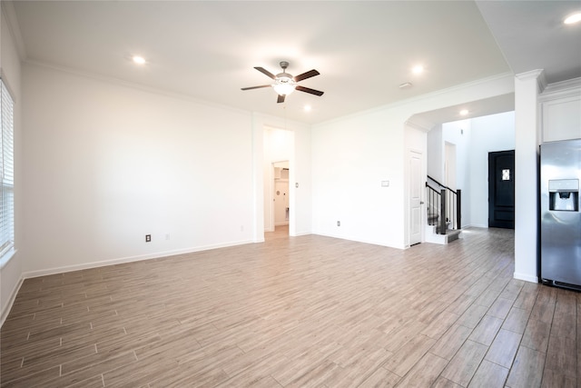 unfurnished living room featuring ornamental molding, wood-type flooring, and ceiling fan