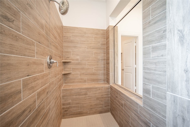 bathroom with tile walls and tiled shower