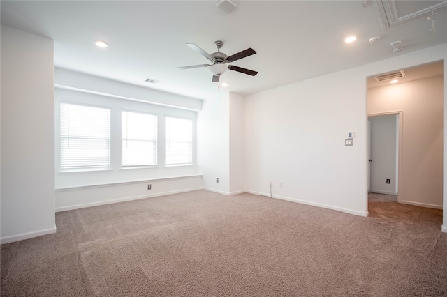 unfurnished room with ceiling fan and carpet