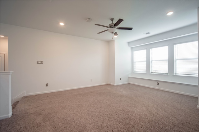 unfurnished room with ceiling fan and light colored carpet