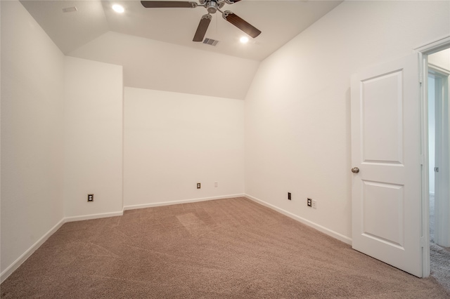 spare room featuring ceiling fan, lofted ceiling, and carpet flooring