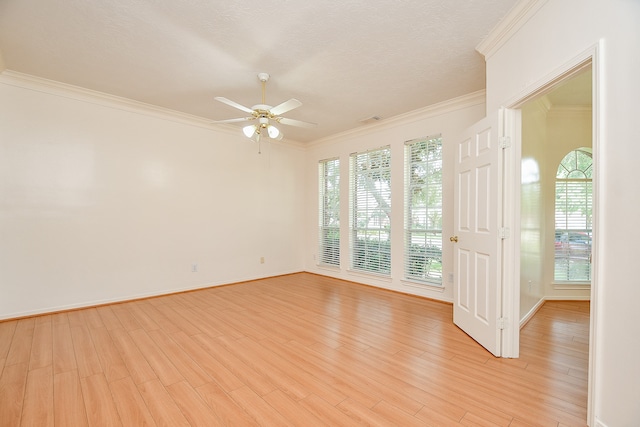 spare room with crown molding, light hardwood / wood-style flooring, ceiling fan, and plenty of natural light