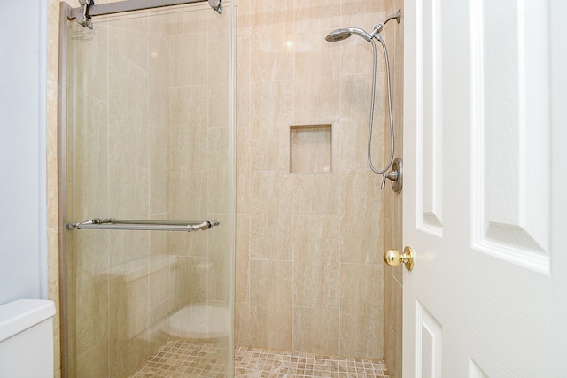 bathroom with walk in shower and toilet