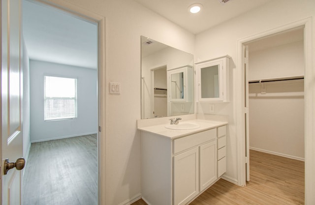 bathroom with vanity and hardwood / wood-style floors