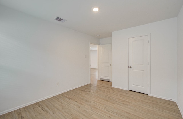 unfurnished room with light hardwood / wood-style floors