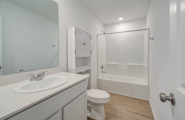 full bathroom featuring wood-type flooring, vanity, toilet, and bathtub / shower combination