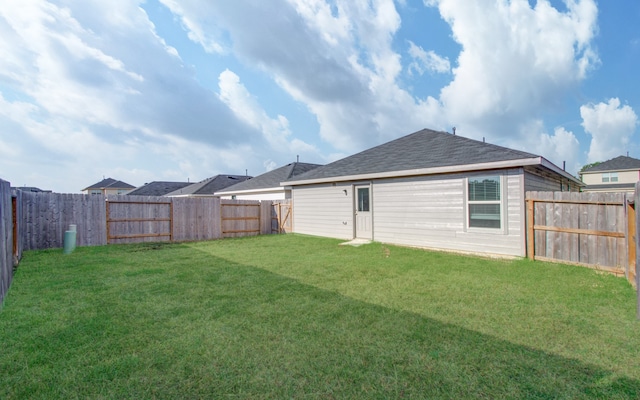 rear view of house featuring a lawn