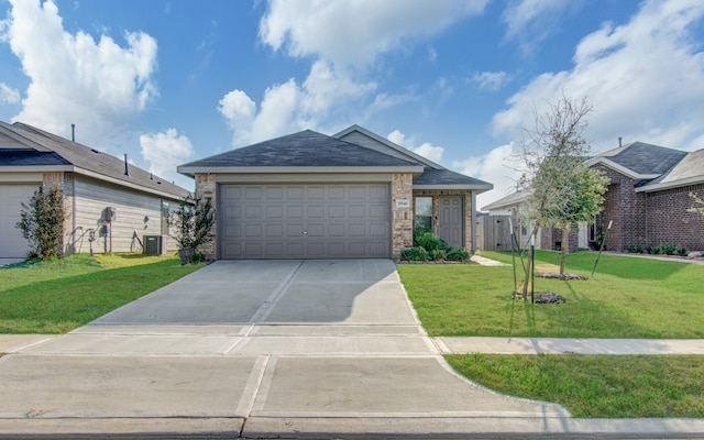 view of front of home with a front lawn, central air condition unit, and a garage