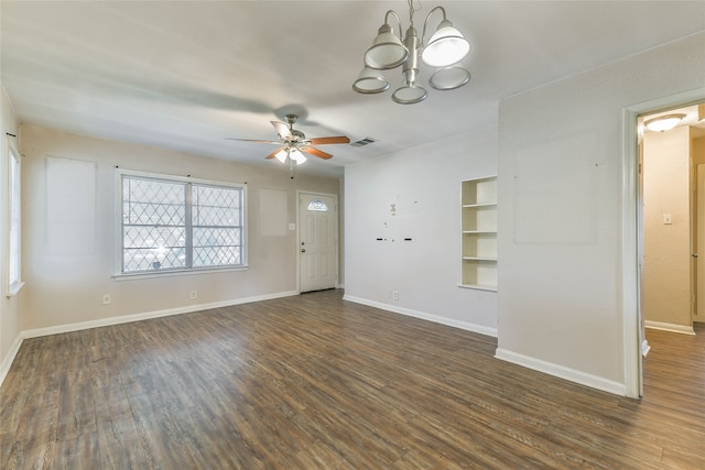 empty room featuring ceiling fan with notable chandelier and dark hardwood / wood-style flooring