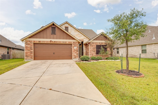 view of front of house featuring central AC, a front yard, and a garage