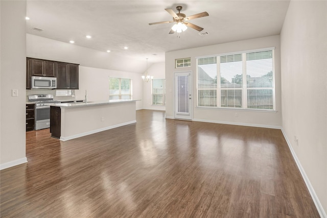 unfurnished living room featuring lofted ceiling, dark hardwood / wood-style floors, and ceiling fan with notable chandelier