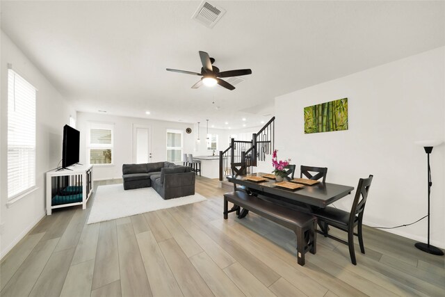 dining space featuring light hardwood / wood-style floors and ceiling fan