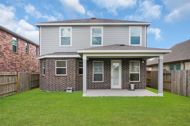 rear view of property with a lawn and a patio