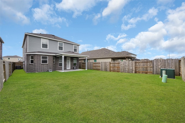 back of property featuring a lawn, a patio area, and central air condition unit