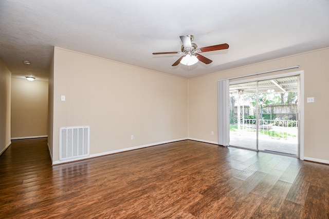 empty room with ornamental molding, dark hardwood / wood-style floors, and ceiling fan