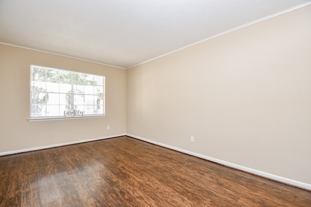 unfurnished room with ornamental molding and dark wood-type flooring