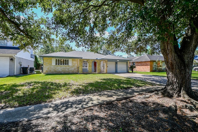 ranch-style home with a garage and a front lawn