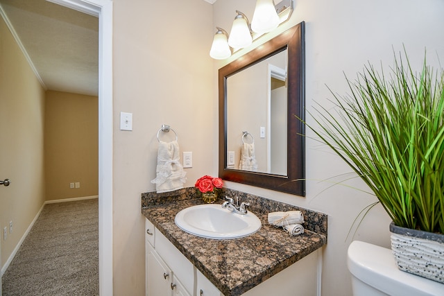 bathroom with toilet, a textured ceiling, and vanity