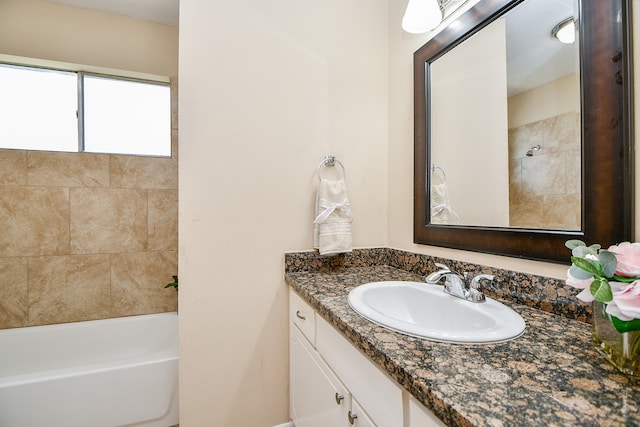 bathroom with vanity and tiled shower / bath combo