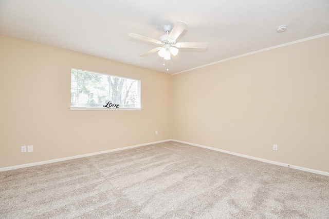 empty room featuring ornamental molding, carpet, and ceiling fan