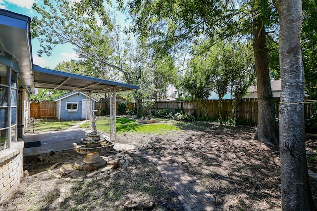 view of yard with a shed and a patio area