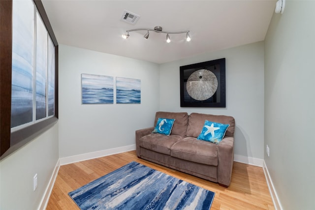 sitting room featuring wood-type flooring and rail lighting