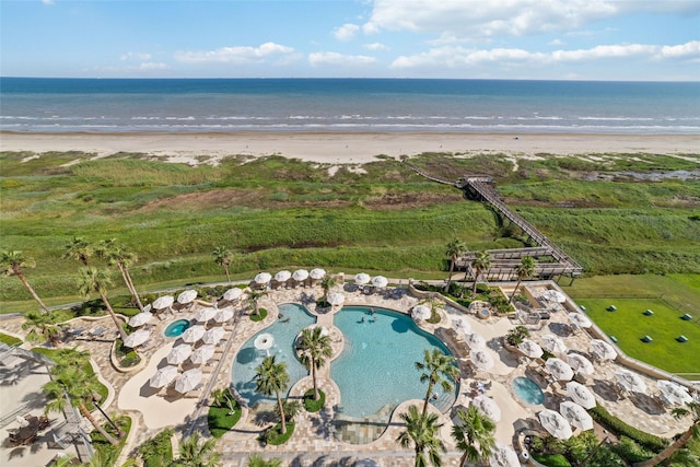 drone / aerial view featuring a view of the beach and a water view