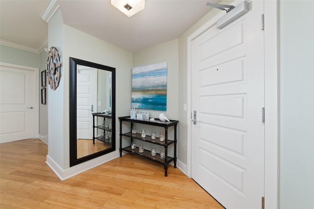 doorway to outside with crown molding and light hardwood / wood-style floors