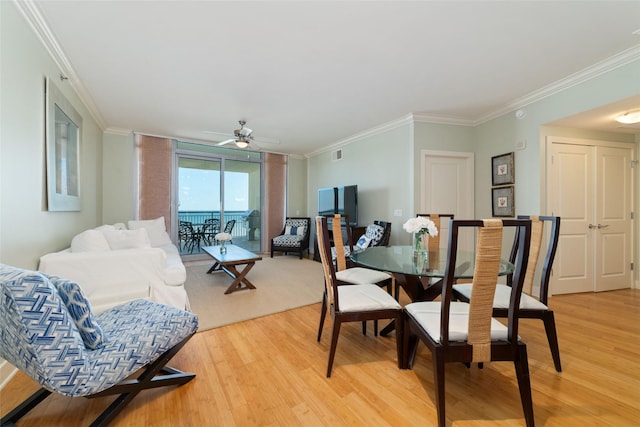 dining area with ceiling fan, ornamental molding, and hardwood / wood-style floors