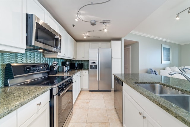 kitchen with white cabinetry, appliances with stainless steel finishes, light stone countertops, and sink