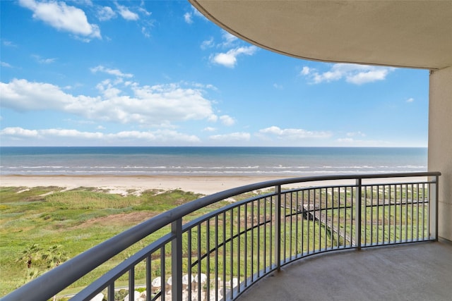 balcony featuring a beach view and a water view