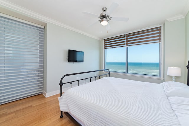 bedroom featuring ceiling fan, ornamental molding, and hardwood / wood-style floors