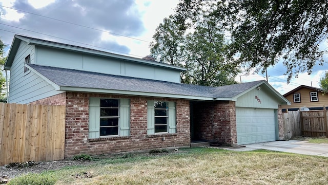 view of front of house featuring a garage and a front lawn