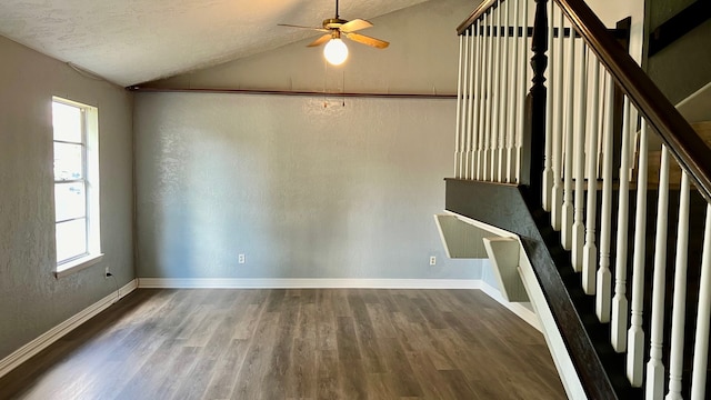 interior space with a textured ceiling, vaulted ceiling, wood-type flooring, and ceiling fan