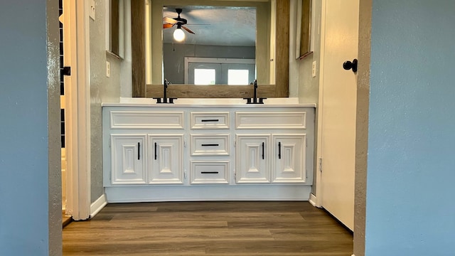 bathroom featuring vanity, hardwood / wood-style flooring, and ceiling fan