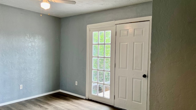 doorway featuring ceiling fan and hardwood / wood-style floors