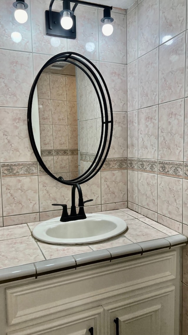 bathroom with tile walls and vanity