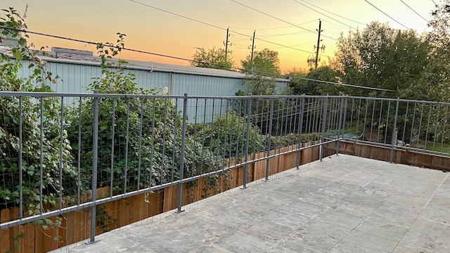 view of patio terrace at dusk