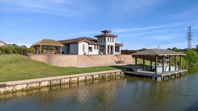 dock area with a water view, a gazebo, and a yard