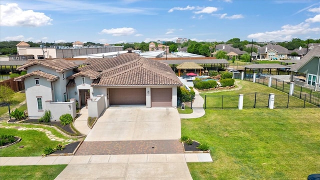 view of front facade with a water view, a garage, and a front yard