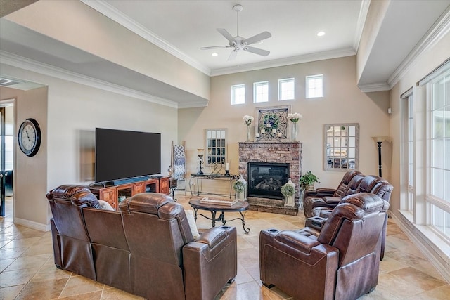 living room featuring a fireplace, ornamental molding, a towering ceiling, and ceiling fan