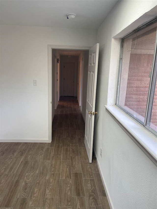 hallway with dark hardwood / wood-style floors