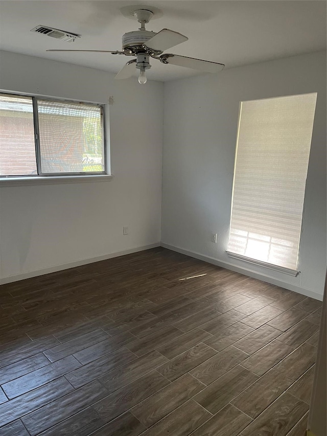 spare room featuring ceiling fan and dark hardwood / wood-style floors