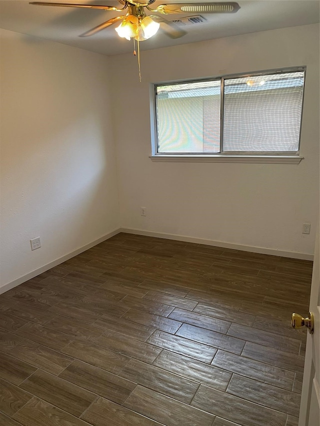 spare room with ceiling fan and dark hardwood / wood-style floors